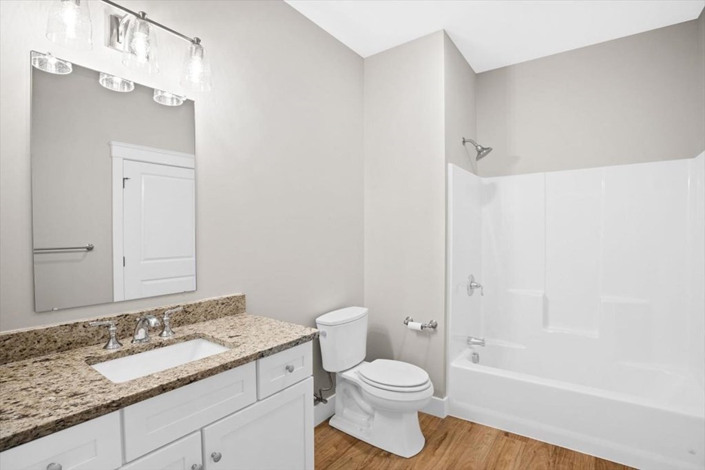57 Long Point Road, Unit 208 Lakeville, MA 02347 - Photo 8 of 27 a bathroom with a granite countertop sink toilet a mirror and shower