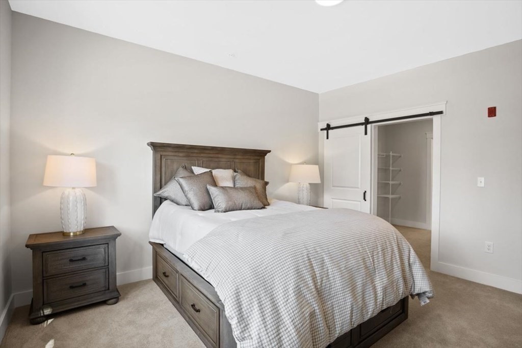 57 Long Point Road, Unit 208 Lakeville, MA 02347 - Photo 9 of 27 a bedroom with a bed and a night stand