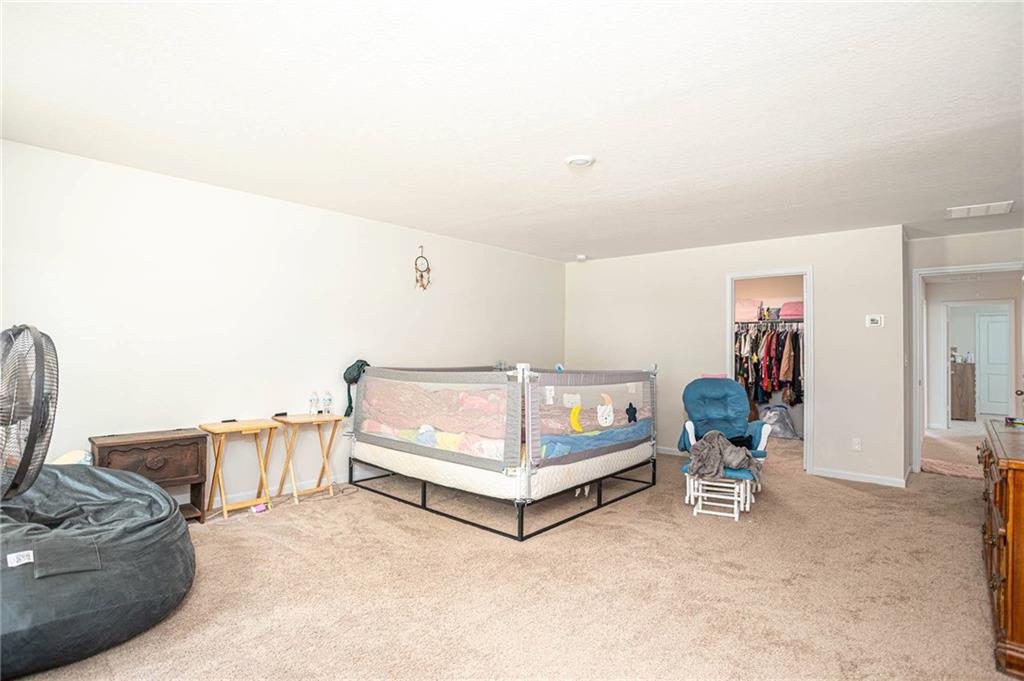 635 Meadows Farm Way Monroe, GA 30655 - Photo 21 of 36 a bed room with a bed and a chair