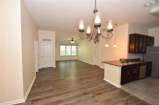 a kitchen with granite countertop a stove and a wooden floors