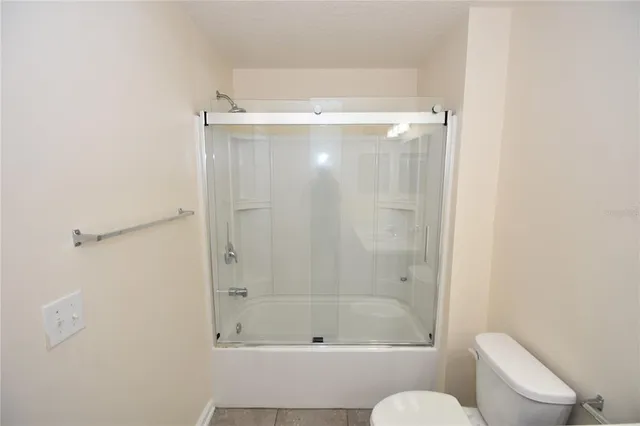 a bathroom with a shower and a toilet