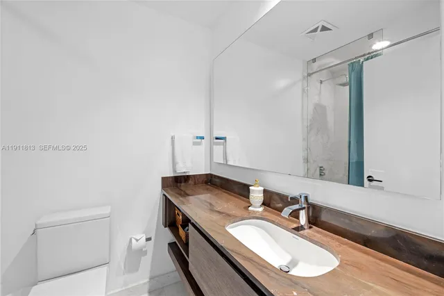 a view of an empty room with glass door and door