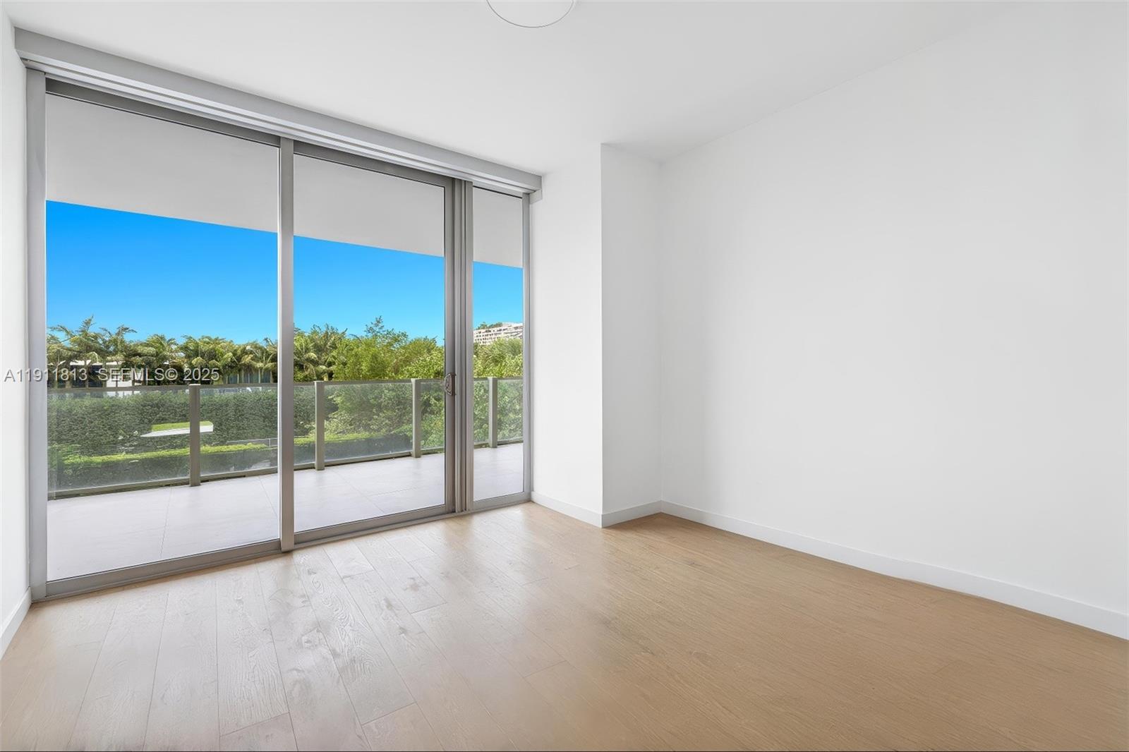 350 Ocean Drive, Unit 301N Key Biscayne, FL 33149 - Photo 13 of 41 a view of an empty room with glass door and door
