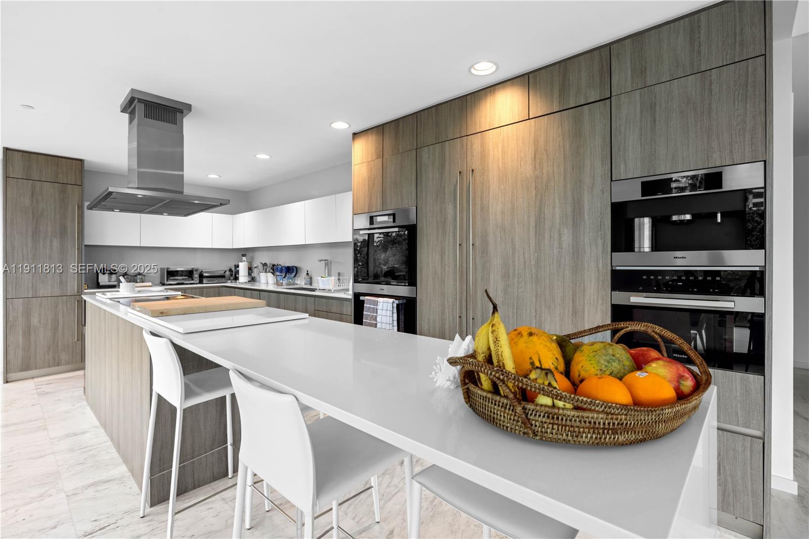 350 Ocean Drive, Unit 301N Key Biscayne, FL 33149 - Photo 16 of 41 a kitchen with stainless steel appliances kitchen island granite countertop a sink and cabinets