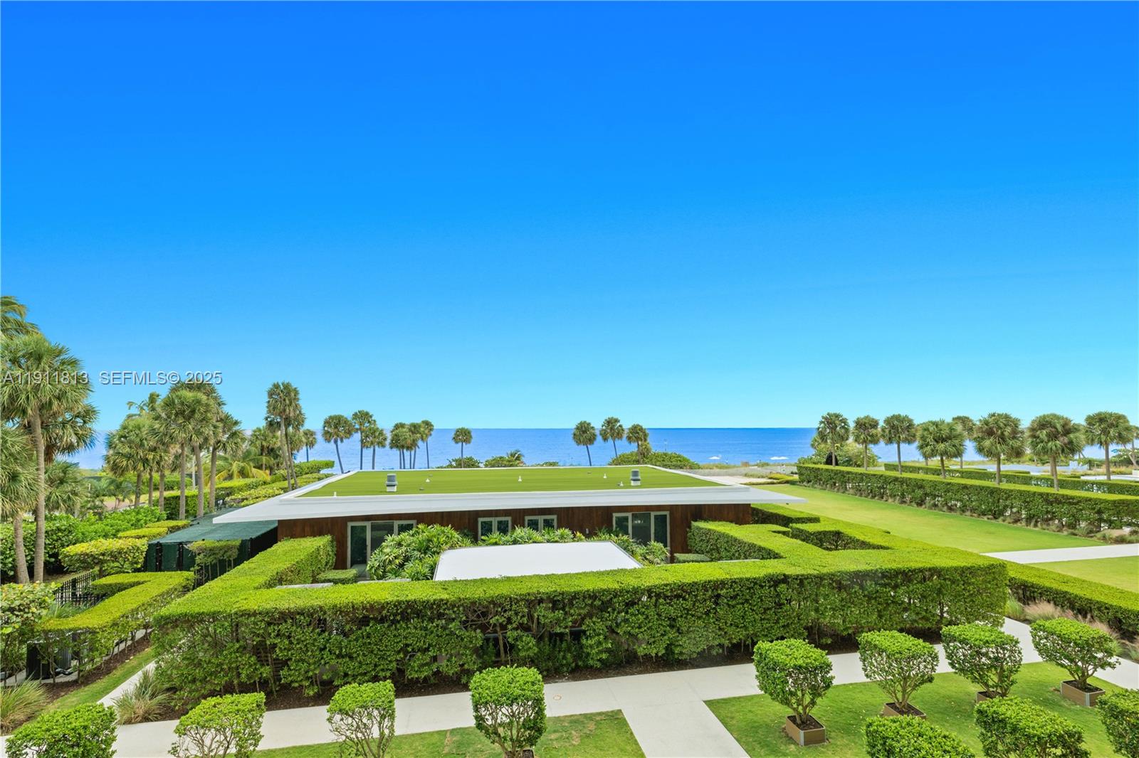 350 Ocean Drive, Unit 301N Key Biscayne, FL 33149 - Photo 2 of 41 a view of a swimming pool with a garden