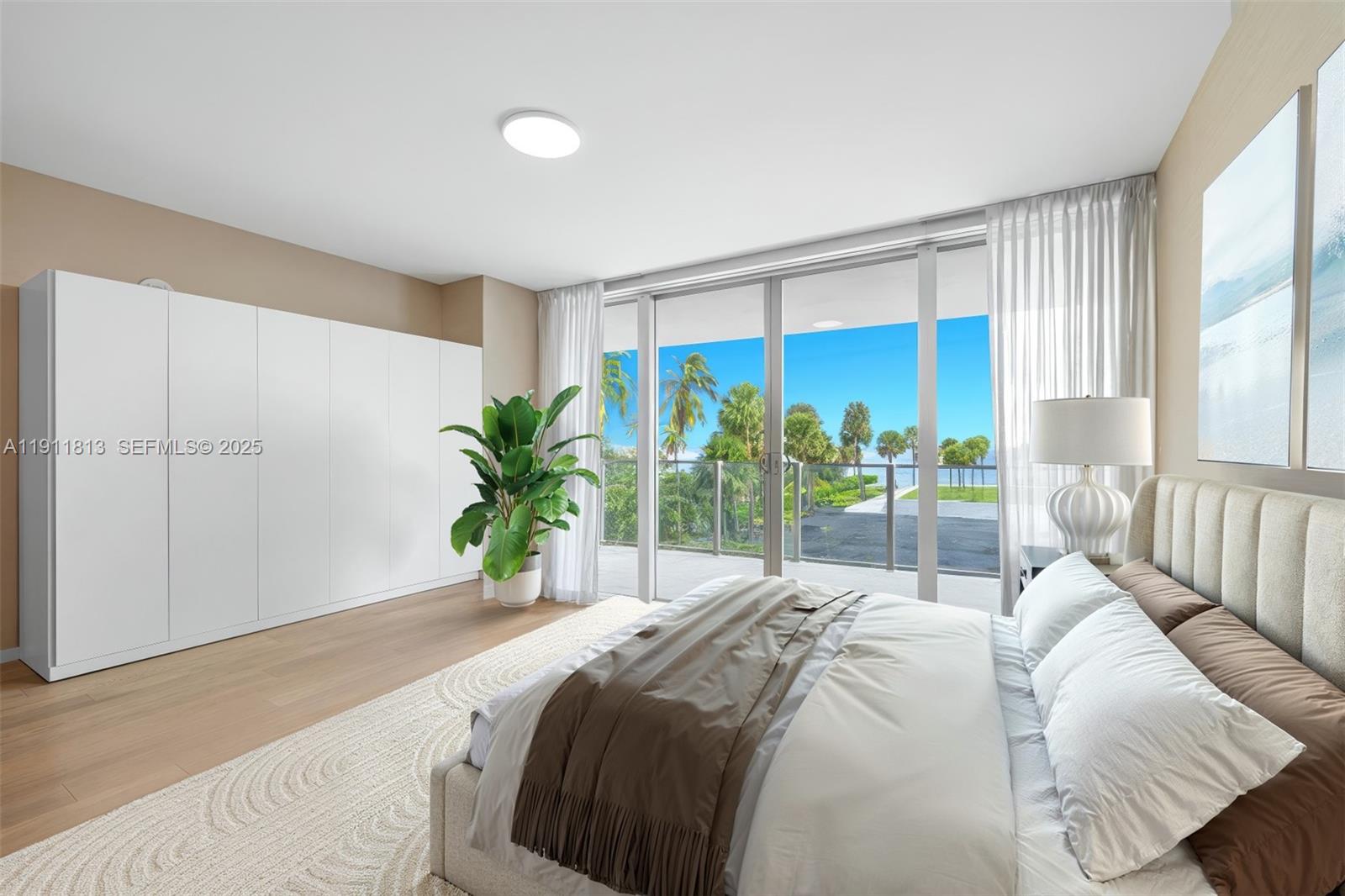 350 Ocean Drive, Unit 301N Key Biscayne, FL 33149 - Photo 25 of 41 a bedroom with a large bed and a large window