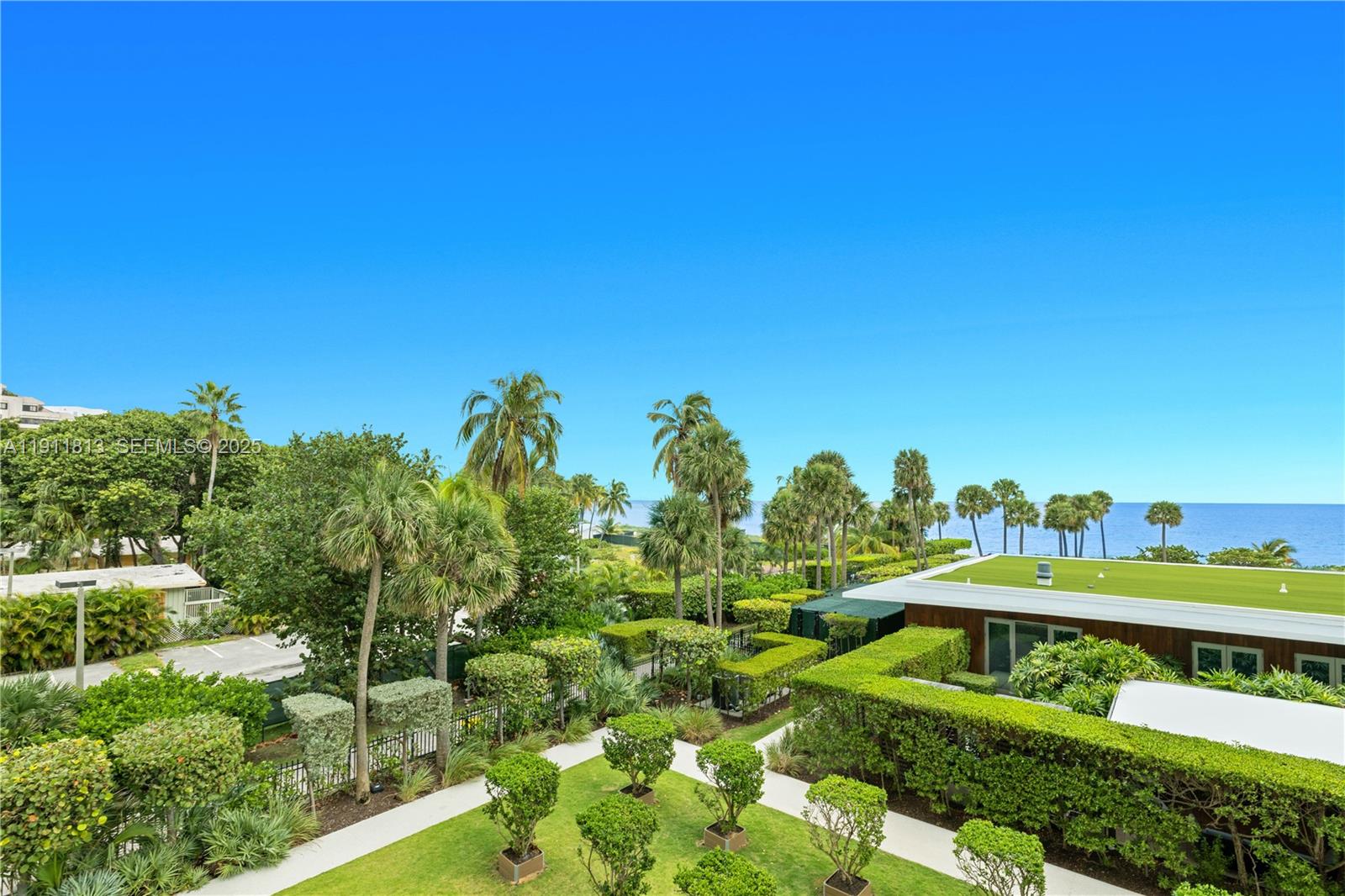 350 Ocean Drive, Unit 301N Key Biscayne, FL 33149 - Photo 32 of 41 a view of a swimming pool with a garden