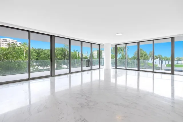 a view of an empty room with large windows