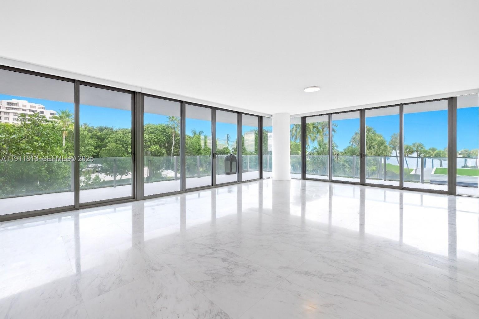 350 Ocean Drive, Unit 301N Key Biscayne, FL 33149 - Photo 4 of 41 a view of an empty room with large windows