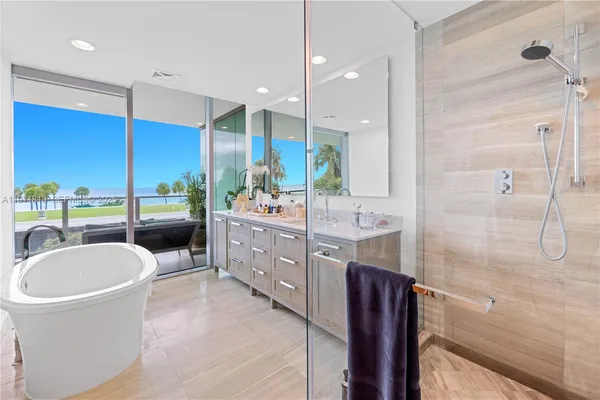 a bathroom with a double vanity sink a mirror and a shower
