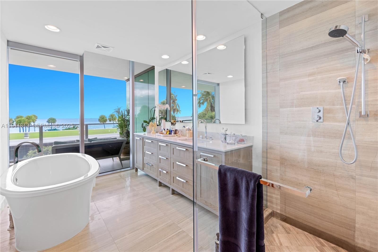350 Ocean Drive, Unit 301N Key Biscayne, FL 33149 - Photo 9 of 41 a bathroom with a double vanity sink a mirror and a shower