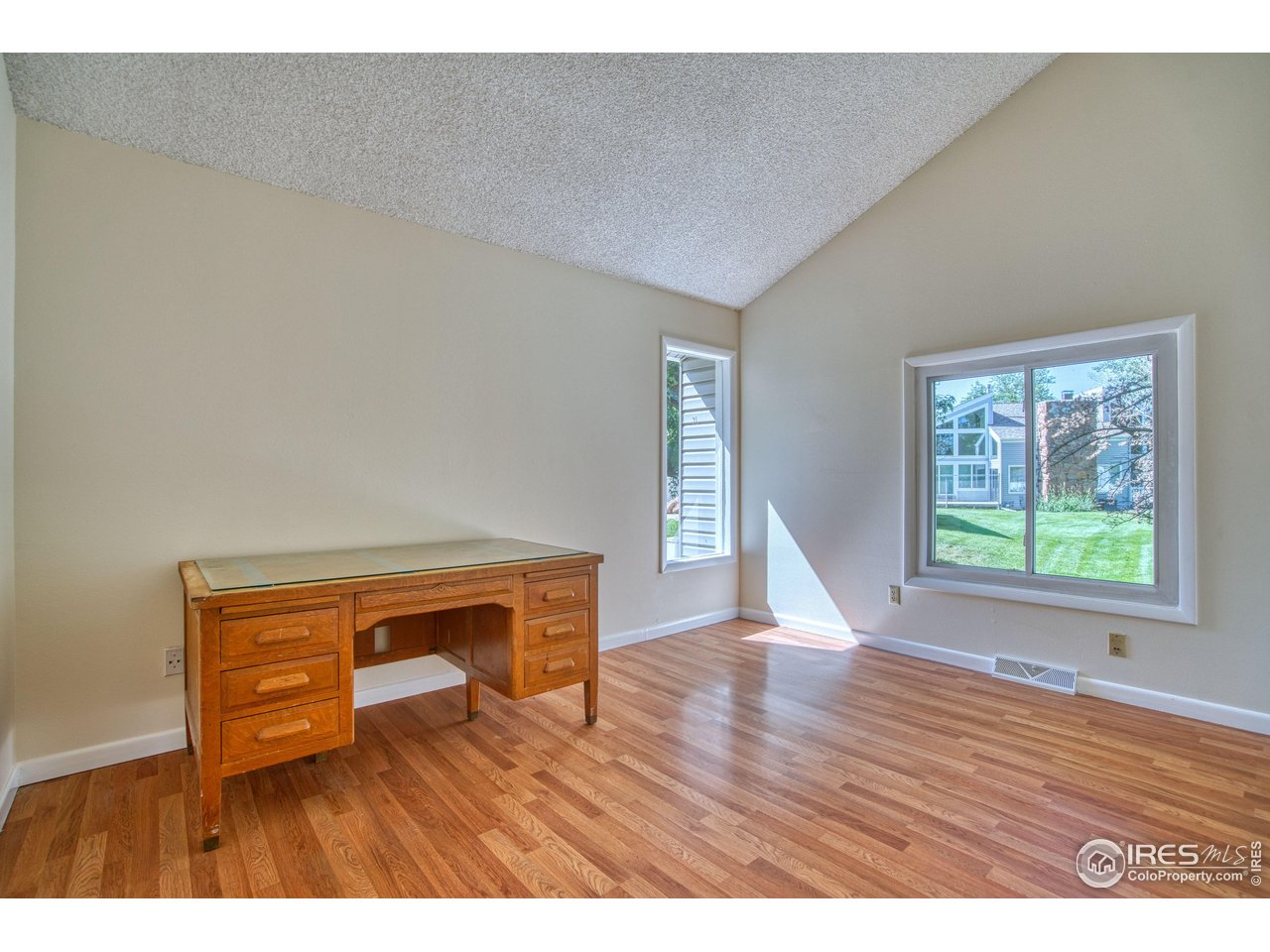 1925 28th Avenue, Unit 30 Greeley, CO 80634 - Photo 16 of 34 a view of an empty room with wooden floor and a window