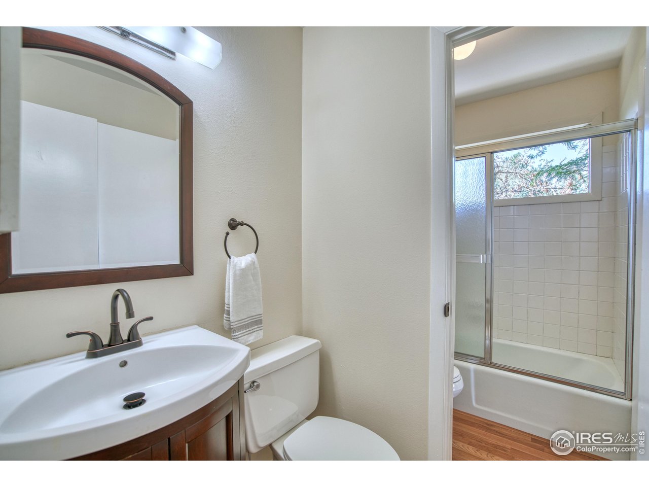 1925 28th Avenue, Unit 30 Greeley, CO 80634 - Photo 17 of 34 a bathroom with a sink and mirror with toilet