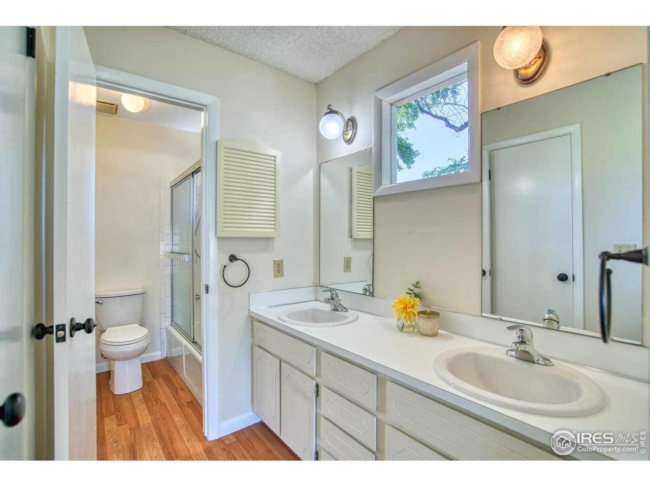1925 28th Avenue, Unit 30 Greeley, CO 80634 - Photo 18 of 34 a bathroom with a sink and a mirror