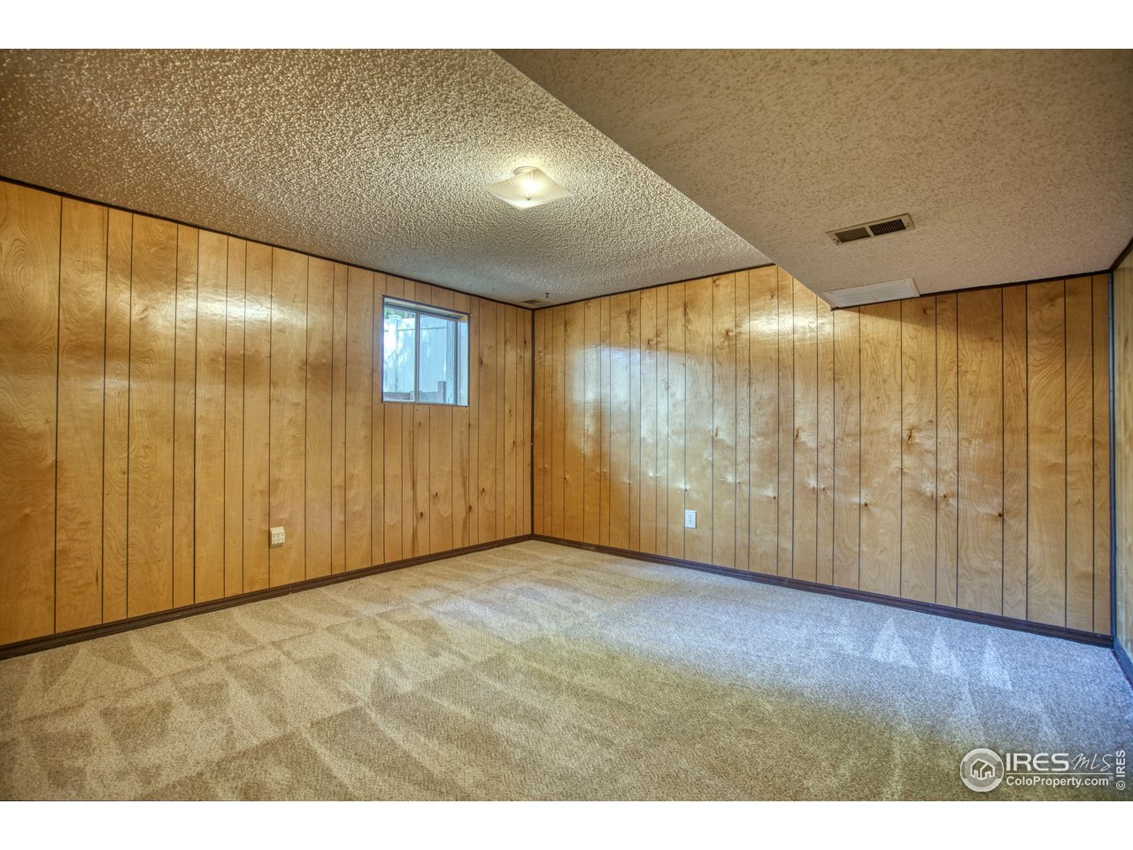 1925 28th Avenue, Unit 30 Greeley, CO 80634 - Photo 32 of 34 a view of an empty room with wooden floor