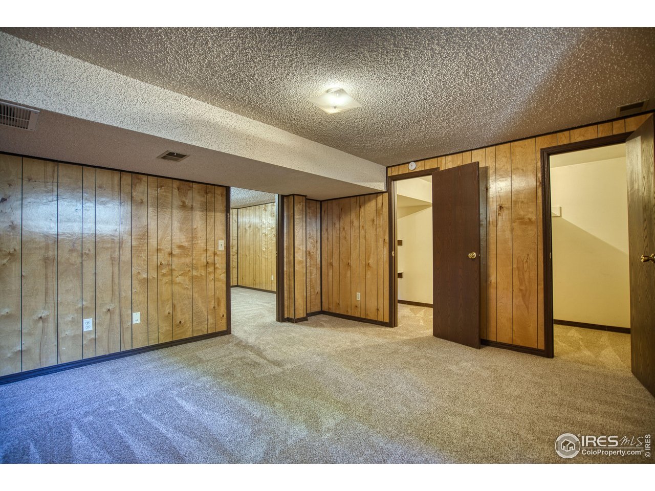 1925 28th Avenue, Unit 30 Greeley, CO 80634 - Photo 34 of 34 a view of an empty room with wooden floor