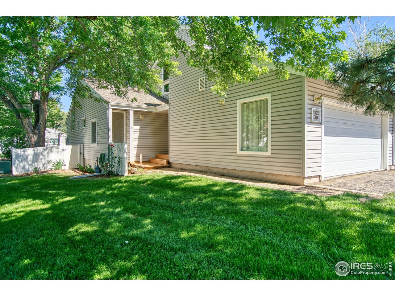 1925 28th Avenue, Unit 30 Greeley, CO 80634 - Photo 6 of 34 a view of a backyard with plants and large tree