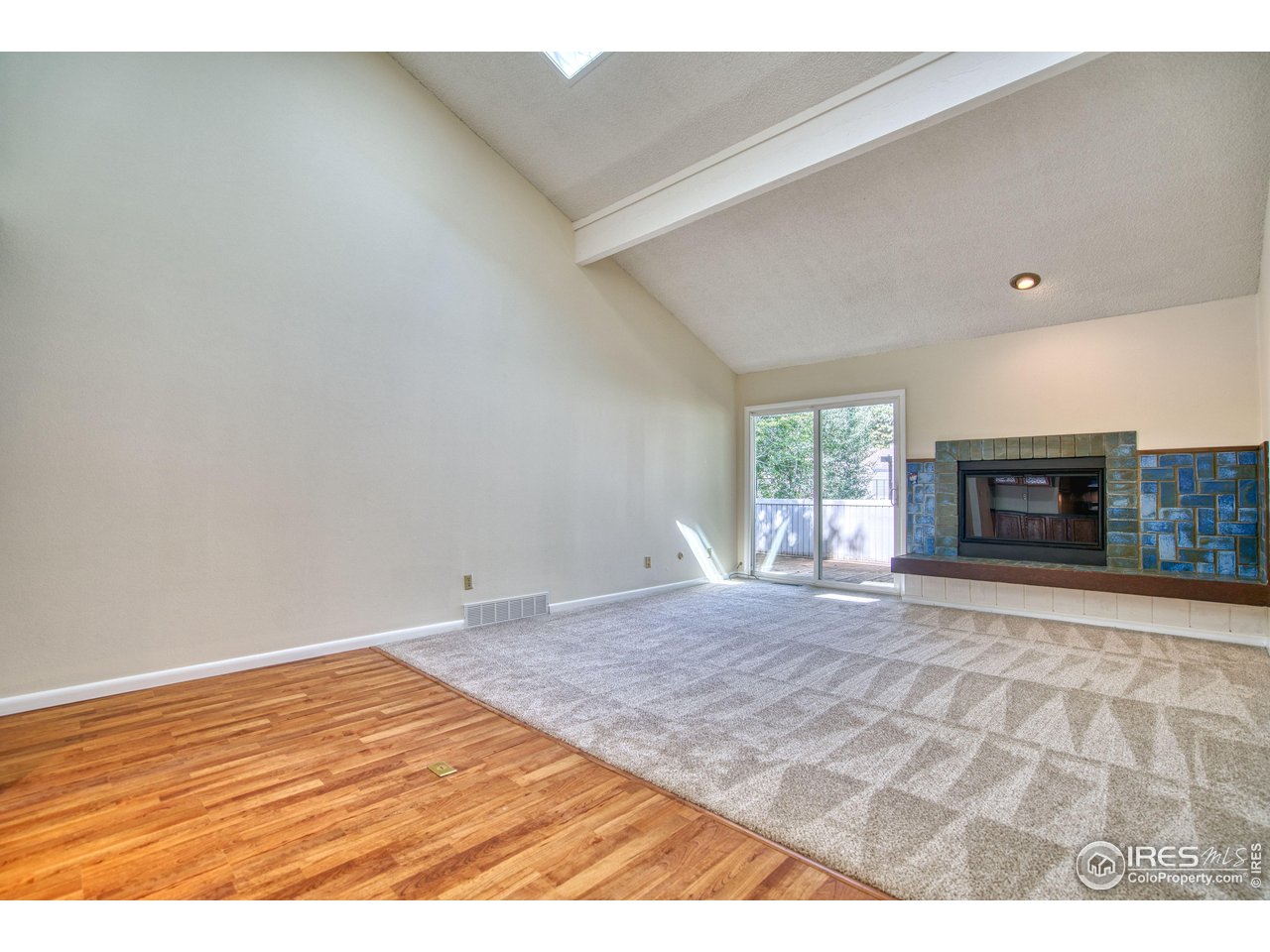 1925 28th Avenue, Unit 30 Greeley, CO 80634 - Photo 7 of 34 a view of empty room with fireplace and wooden floor
