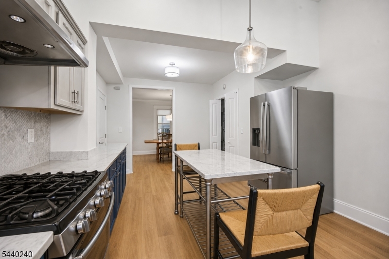 10 Mountain Place Montclair, NJ 07043 - Photo 8 of 21 a kitchen with stainless steel appliances a stove a refrigerator and a dining table