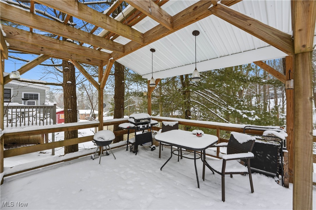 4254 Doral Road Southwest Carrollton, OH 44615 - Photo 18 of 46 Snow covered deck with area for grilling and outdoor dining space
