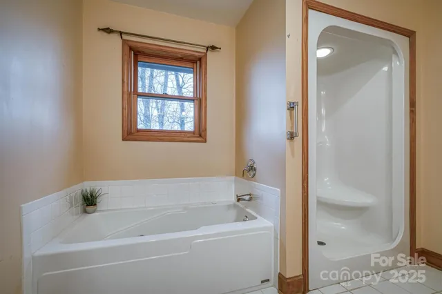 a white bath tub sitting next to a shower