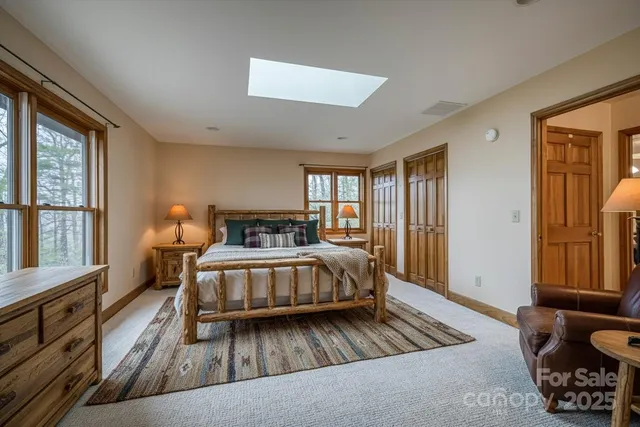 a spacious bedroom with a bed and wooden floor