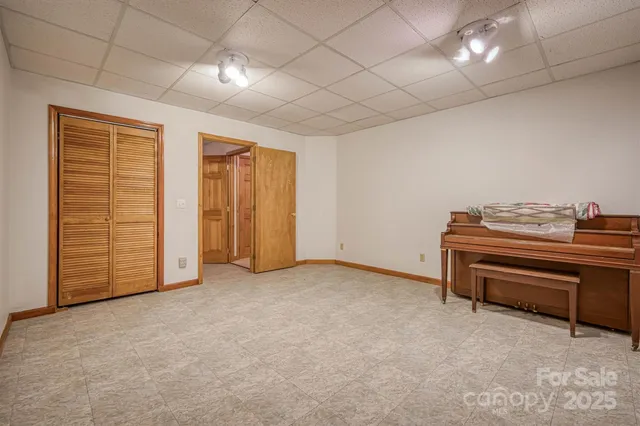 an empty room with furniture and a ceiling fan