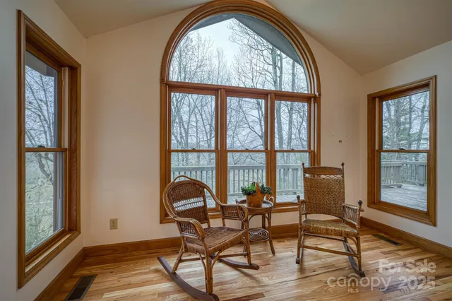 a view of a room with furniture and windows