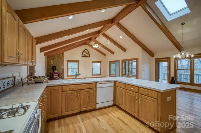 a kitchen with sink a stove and cabinets