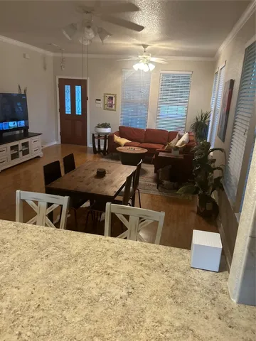 a dinning room with furniture and a flat screen tv
