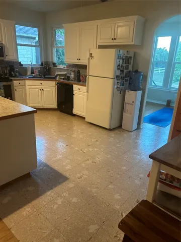 a kitchen with a refrigerator and a stove