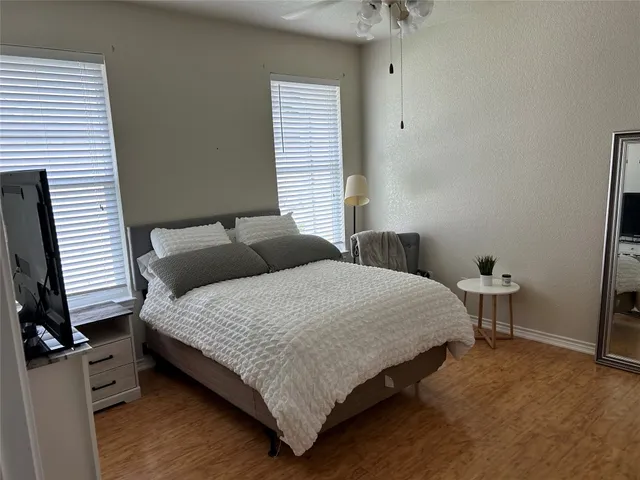 a bedroom with a bed and a table in it