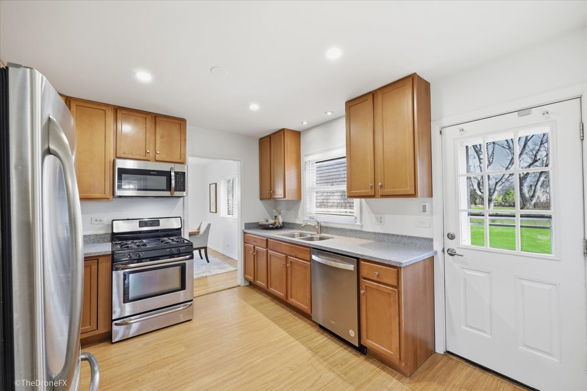 1519 Foothill Drive Wheaton, IL 60189 - Photo 18 of 44 a kitchen with stainless steel appliances a stove sink and refrigerator