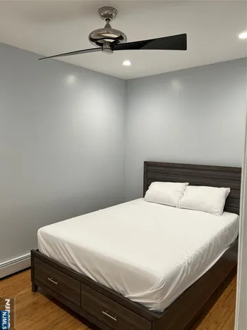 a bedroom with a bed and a ceiling fan