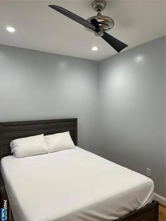 a bedroom with a bed and chandelier