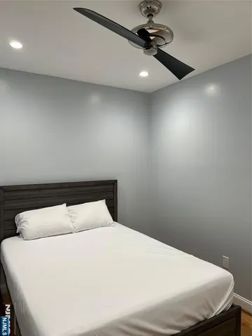 a bedroom with a bed and chandelier