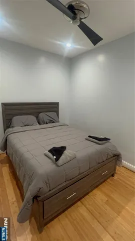 a bedroom with a bed and a night stand