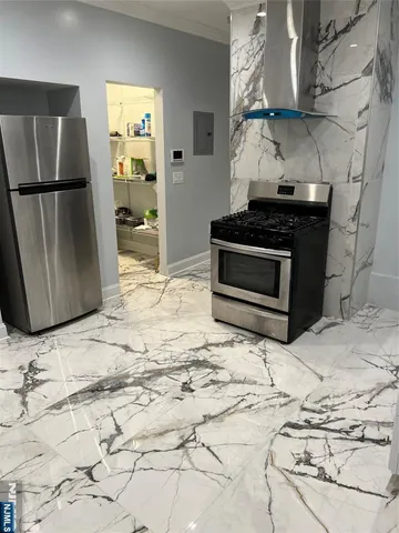 a kitchen with granite countertop a stove and a refrigerator