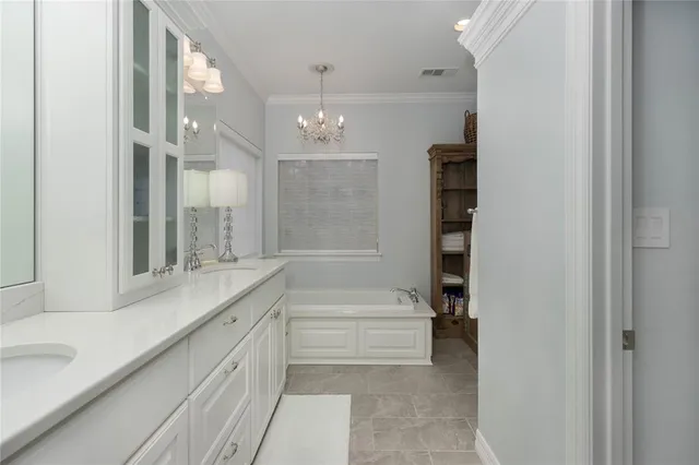 a bathroom with a granite countertop sink mirror and a bath tub