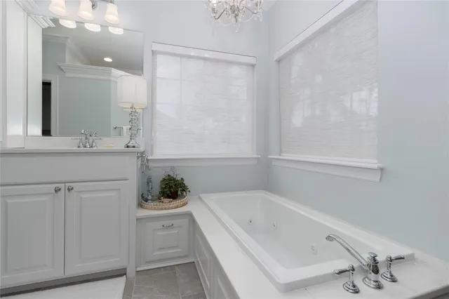 a bathroom with a bathtub sink and mirror