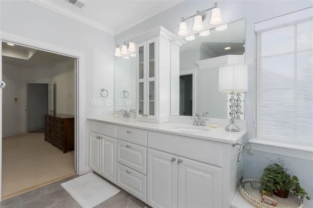 a bathroom with a sink double vanity and a mirror