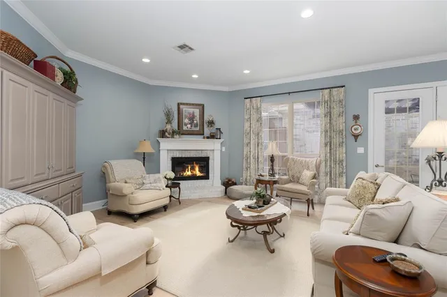 a living room with furniture fireplace and a table