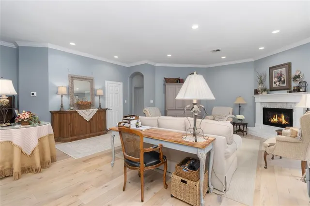 a living room with furniture a table and a fireplace