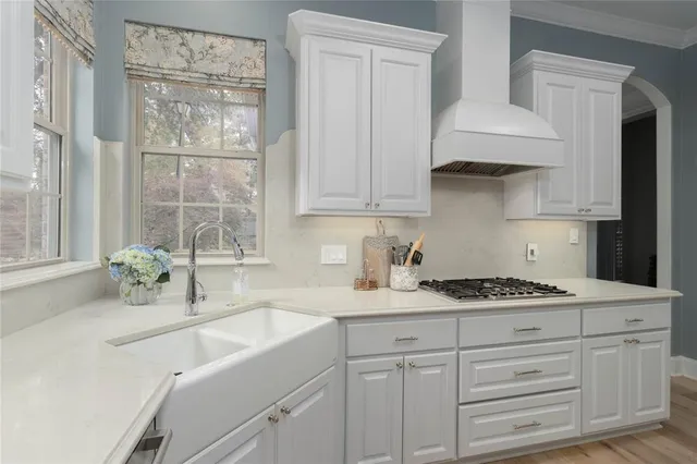 a kitchen with stainless steel appliances granite countertop a sink stove and cabinets