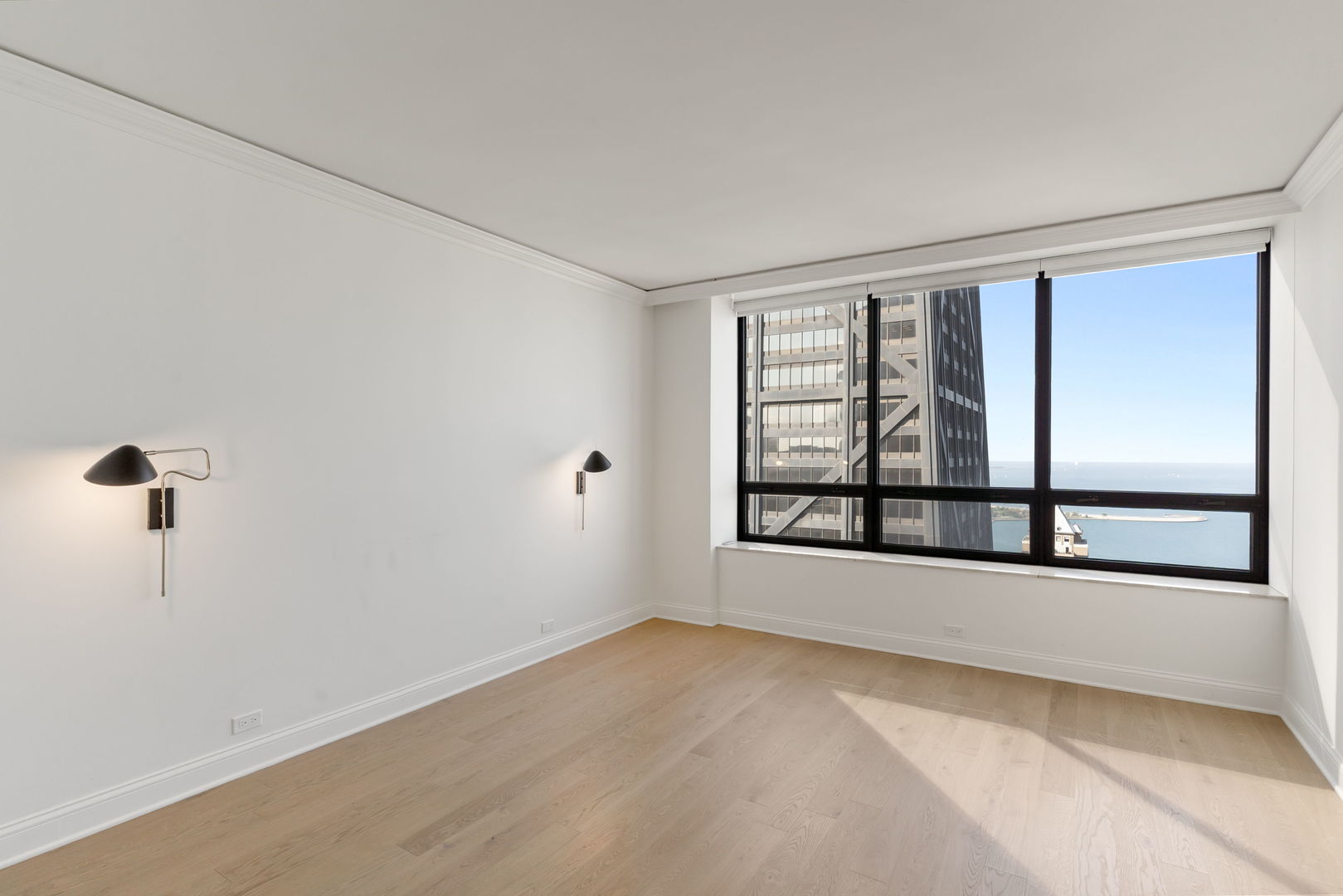 180 East Pearson Street, Unit 3502 Chicago, IL 60611 - Photo 13 of 33 wooden floor in an empty room with a window