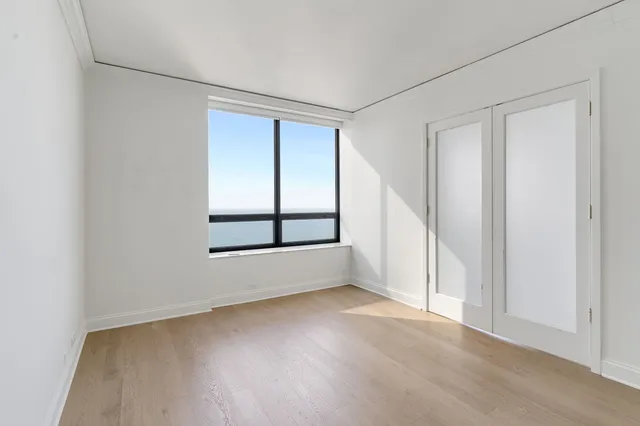 a view of a hallway with wooden shelves