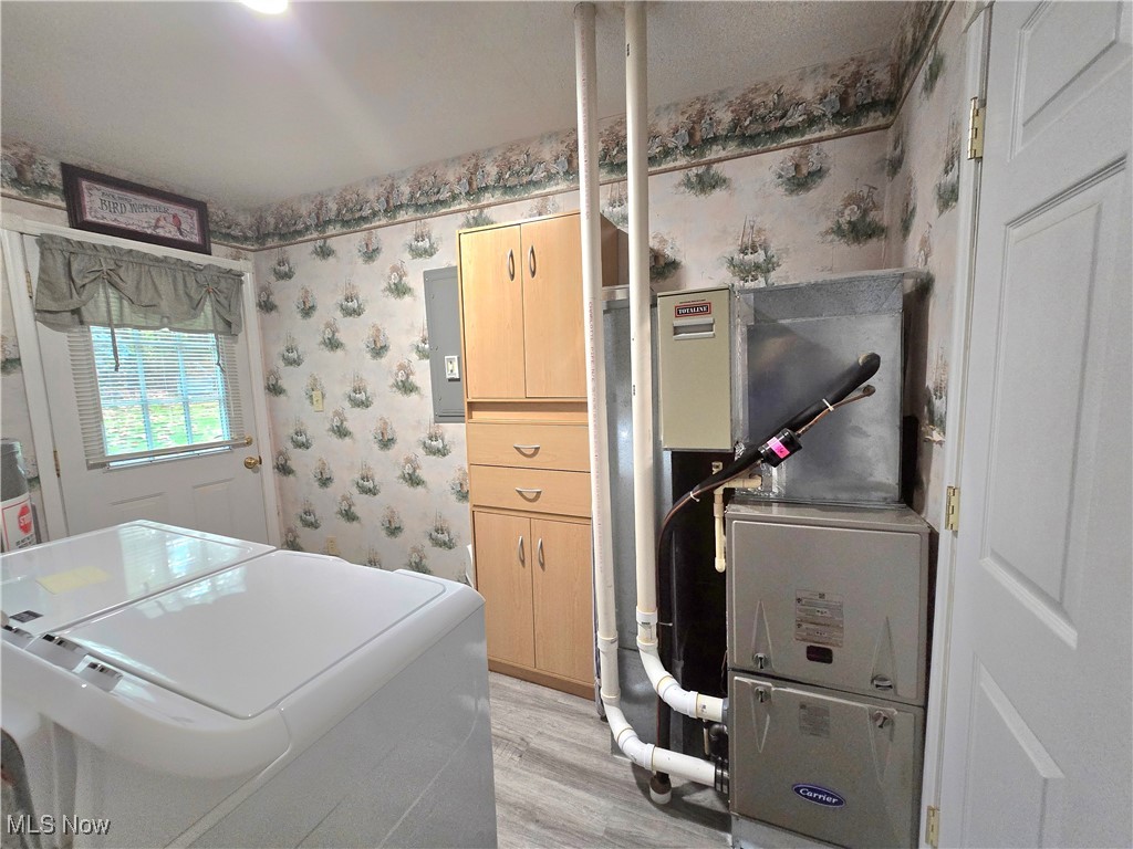 8019 Kroft Road Mount Perry, OH 43760 - Photo 41 of 41 Washroom with wallpapered walls, light wood-style flooring, heating unit, separate washer and dryer, and electric panel