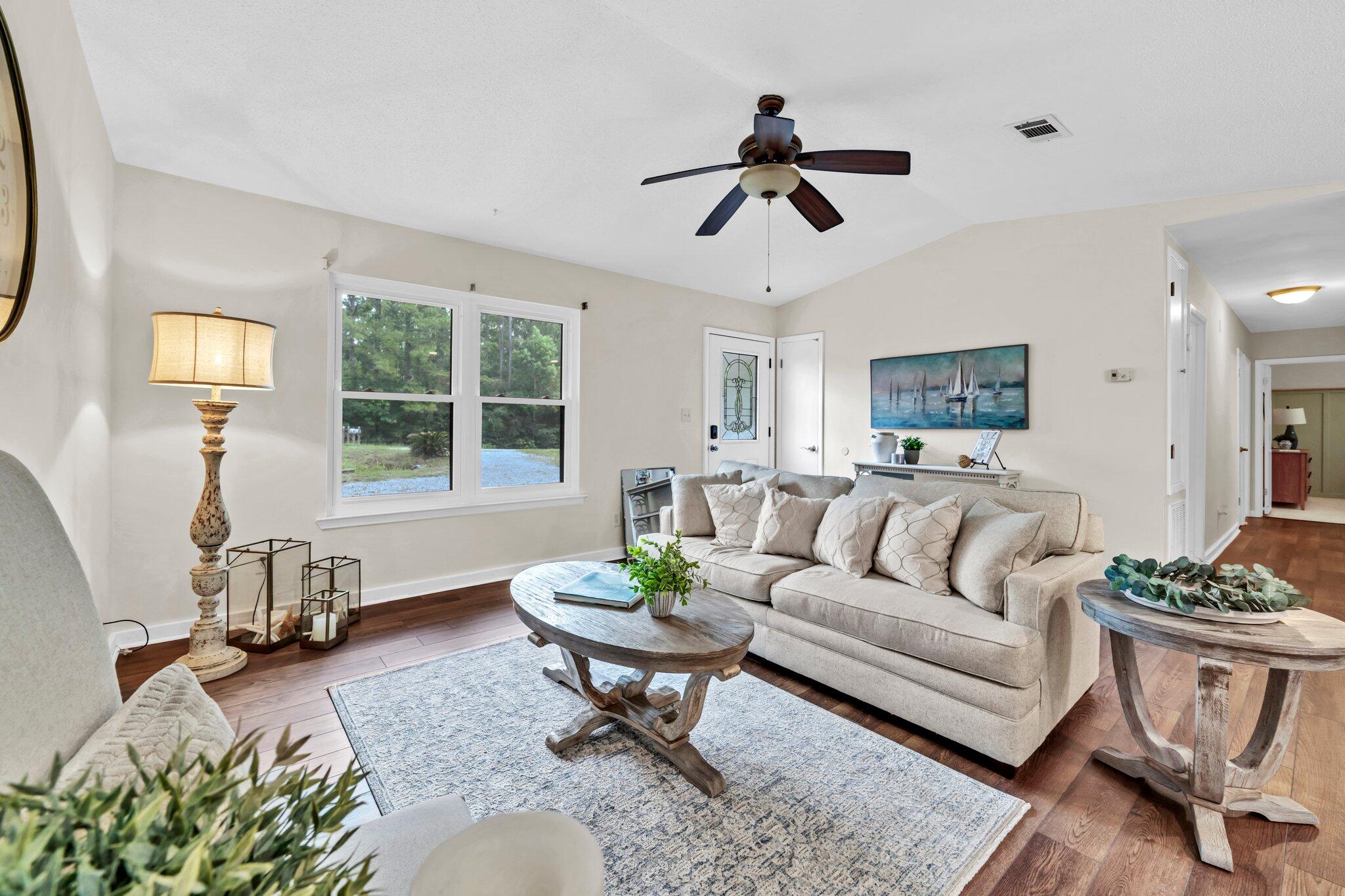 5241 Bob Sikes Road DeFuniak Springs, FL 32435 - Photo 11 of 35 a living room with furniture and a large window