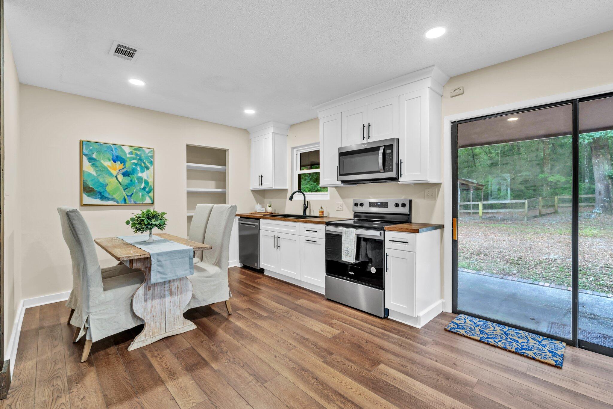 5241 Bob Sikes Road DeFuniak Springs, FL 32435 - Photo 13 of 35 a kitchen with a sink cabinets stainless steel appliances and a window