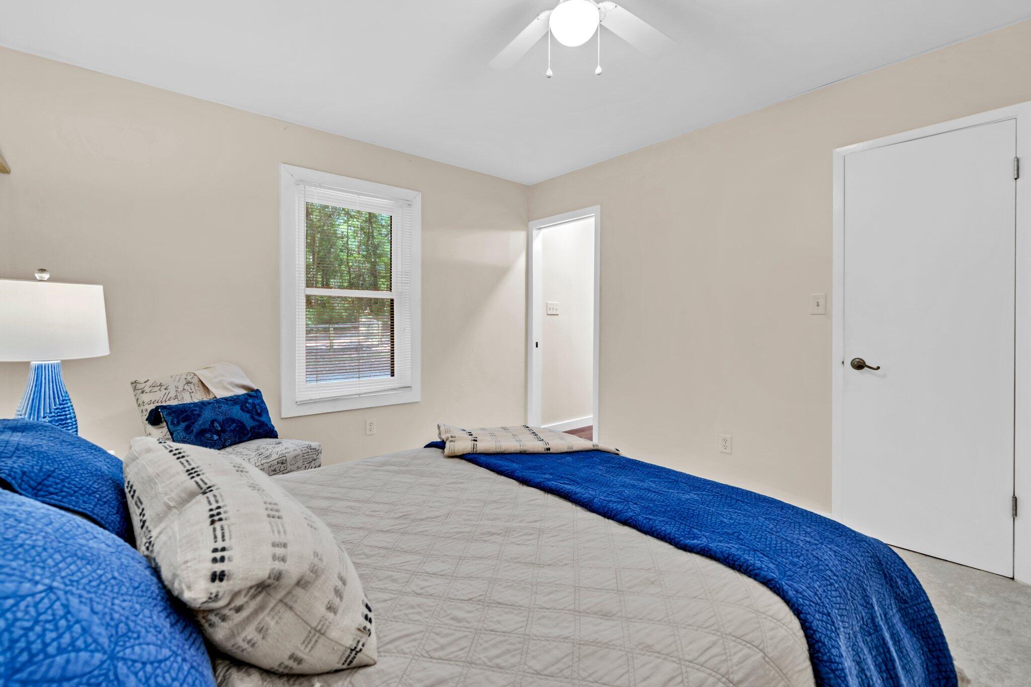 5241 Bob Sikes Road DeFuniak Springs, FL 32435 - Photo 23 of 35 a bedroom with a bed and a lamp